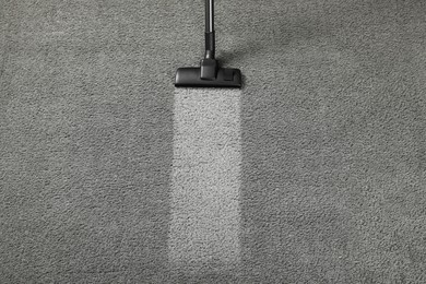 Photo of Vacuuming grey carpet. Clean area after using device, top view. Space for text