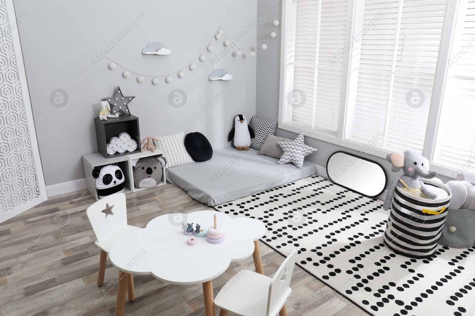 Photo of Montessori bedroom interior with floor bed and toys