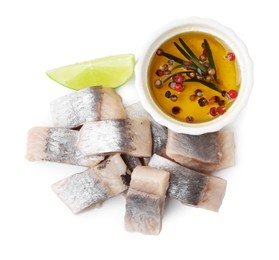 Photo of Pieces of tasty fish, lime and marinade isolated on white, top view