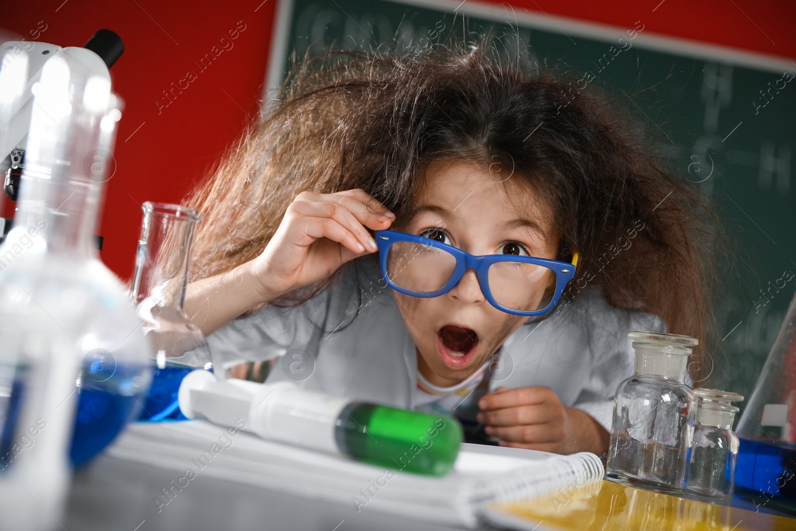 Photo of Emotional child in laboratory after explosion. Dangerous experiment