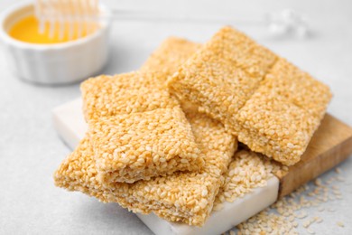 Photo of Delicious sweet kozinaki bars on white table, closeup