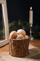 Photo of Homemade walnut shaped cookies with boiled condensed milk on wooden table, space for text