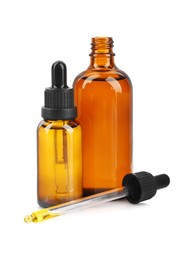 Photo of Glass bottles and pipette with tincture isolated on white