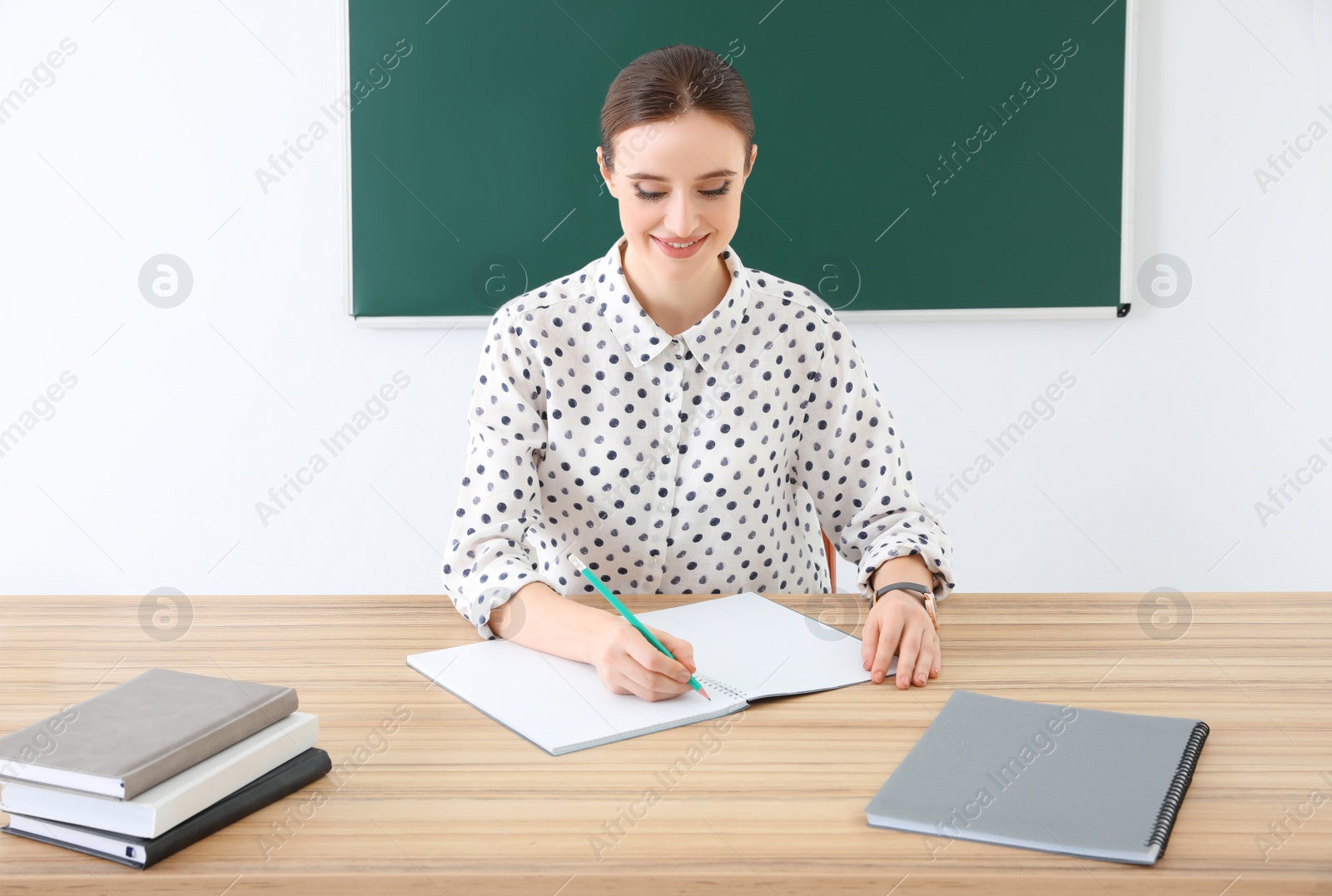 Photo of Portrait of young female teacher in classroom