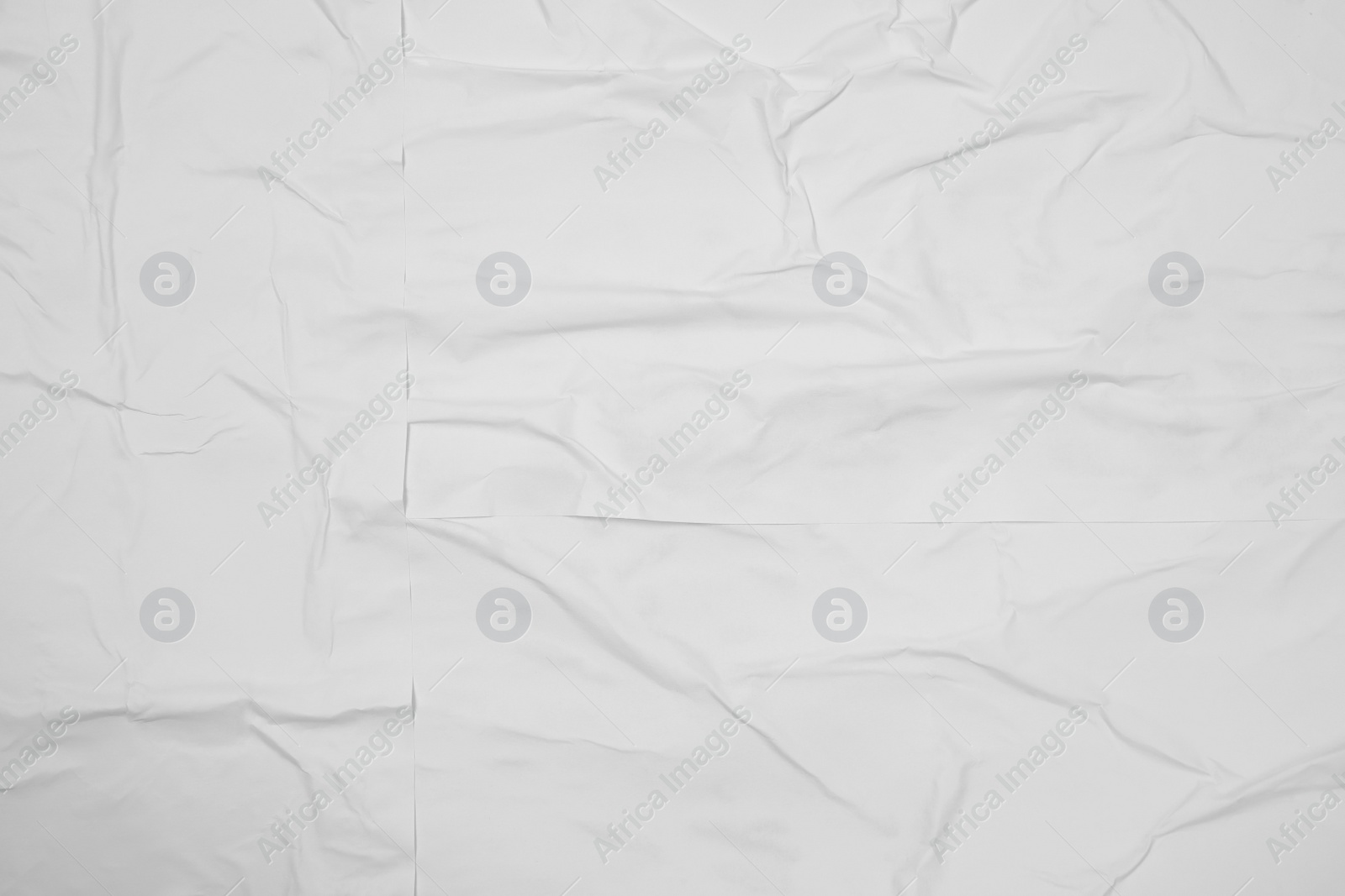 Photo of Top view of white creased blank poster as background, closeup