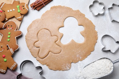 Flat lay composition with homemade gingerbread man cookies on light grey table