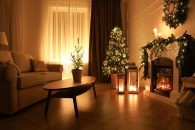 Beautiful room interior with fireplace and Christmas decor in evening