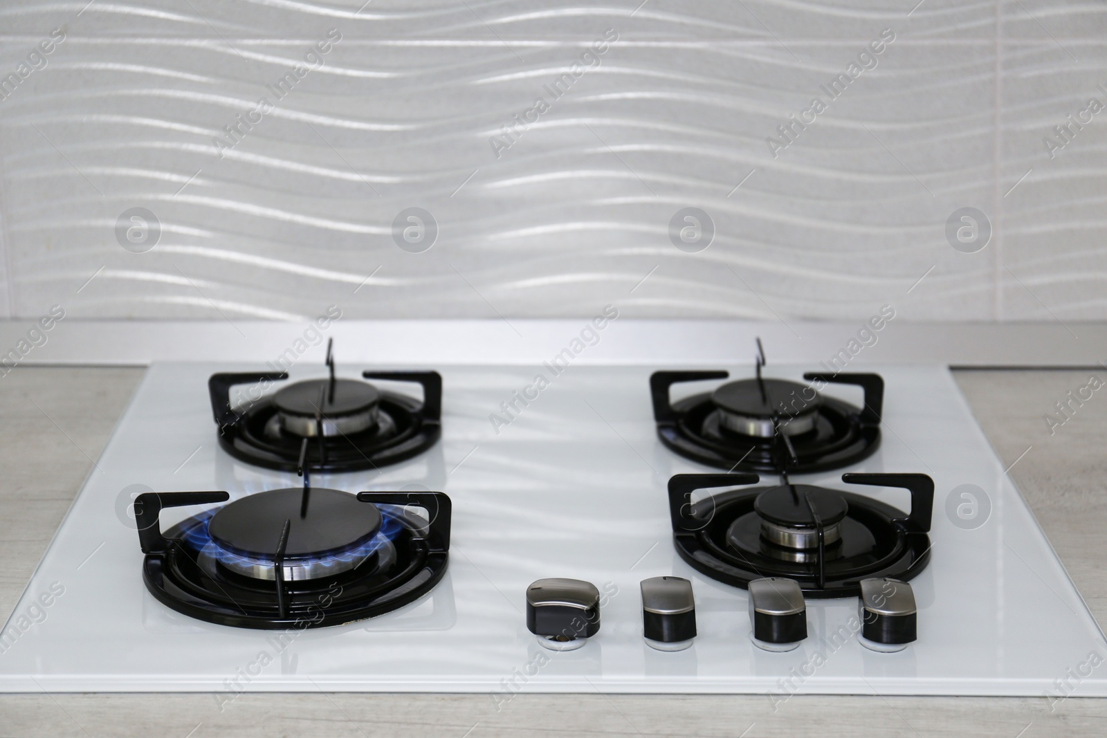 Photo of Modern kitchen stove with burning gas indoors