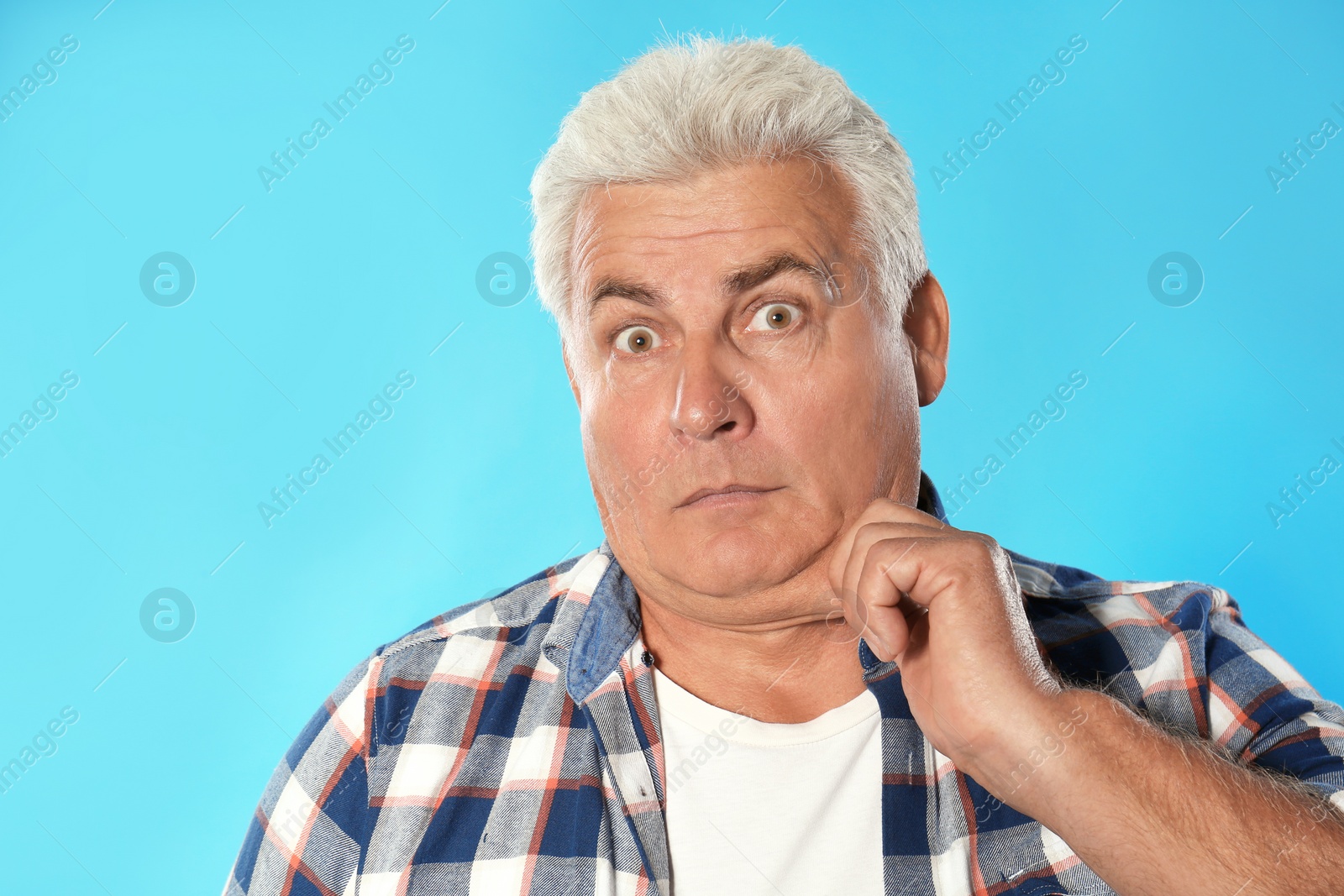 Photo of Emotional mature man with double chin on blue background