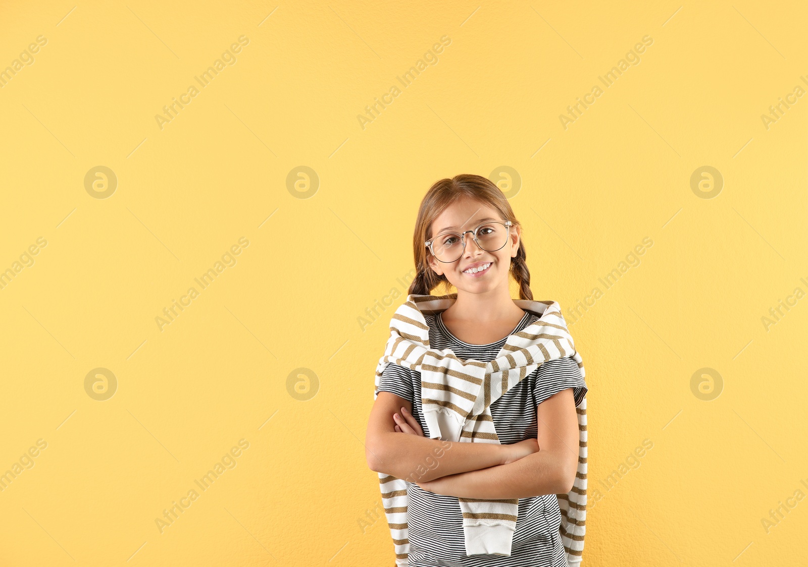 Photo of Pretty preteen girl posing against color background. Space for text