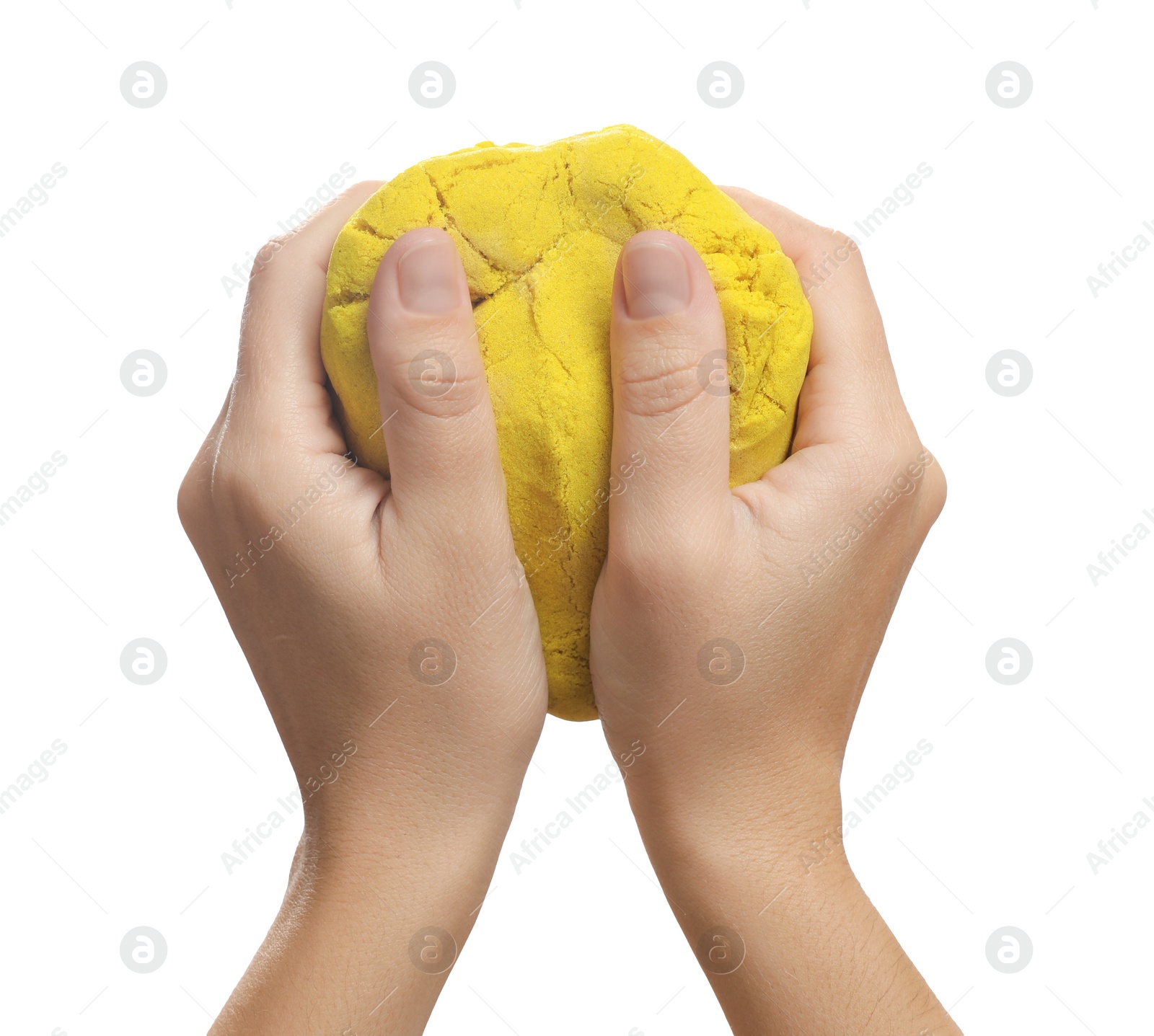 Photo of Woman playing with yellow kinetic sand on white background, closeup