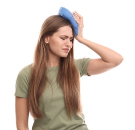 Unhappy woman using cold pack to cure headache on white background