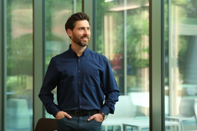 Portrait of handsome stylish man in office