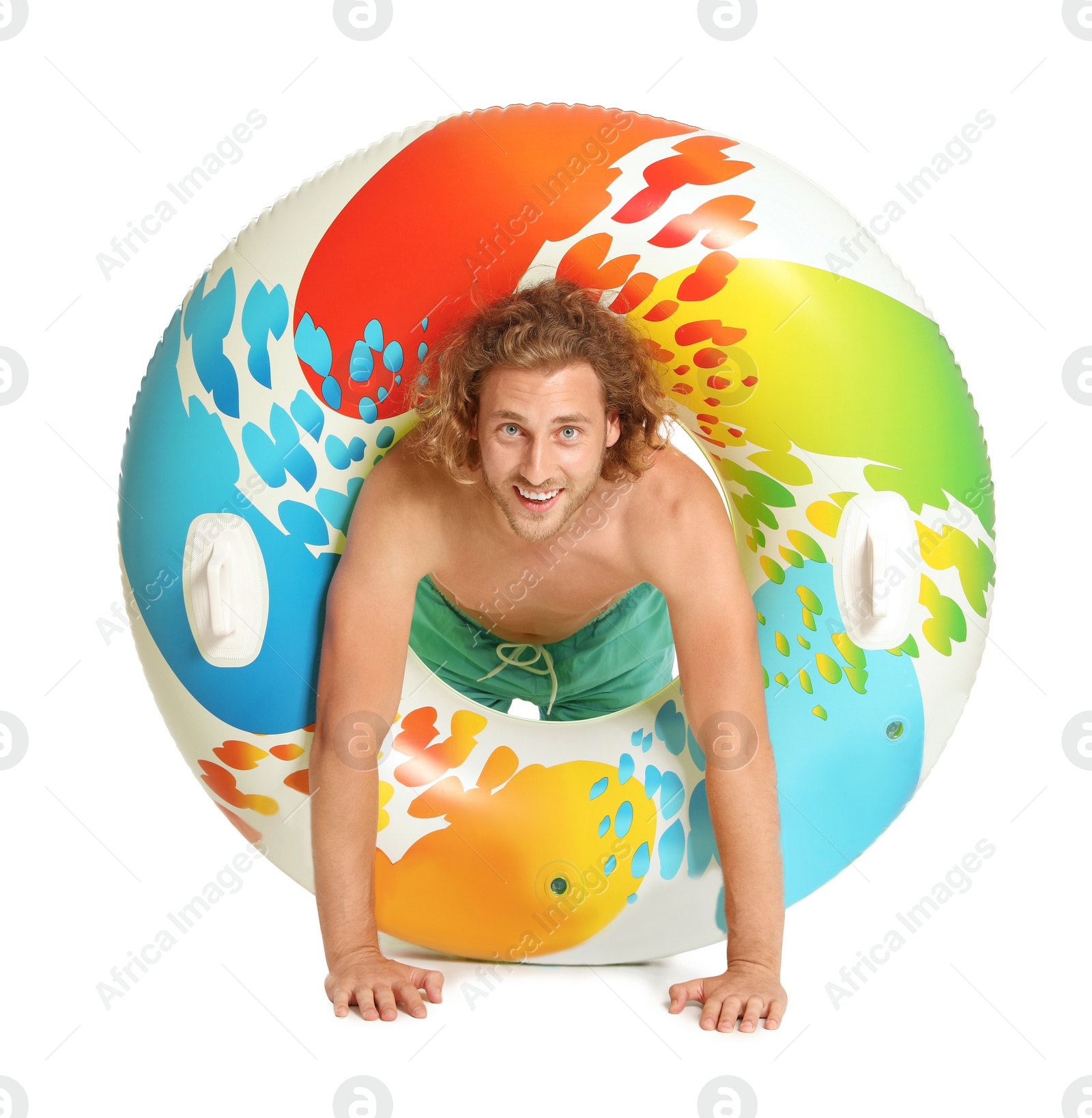 Photo of Attractive young man in swimwear with colorful inflatable ring on white background