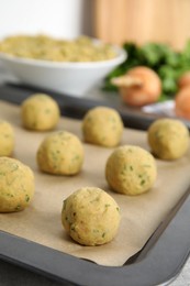 Raw falafel balls on baking sheet, closeup