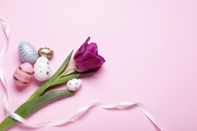 Flat lay composition with tulip and beautifully painted eggs on pink background, space for text. Easter celebration