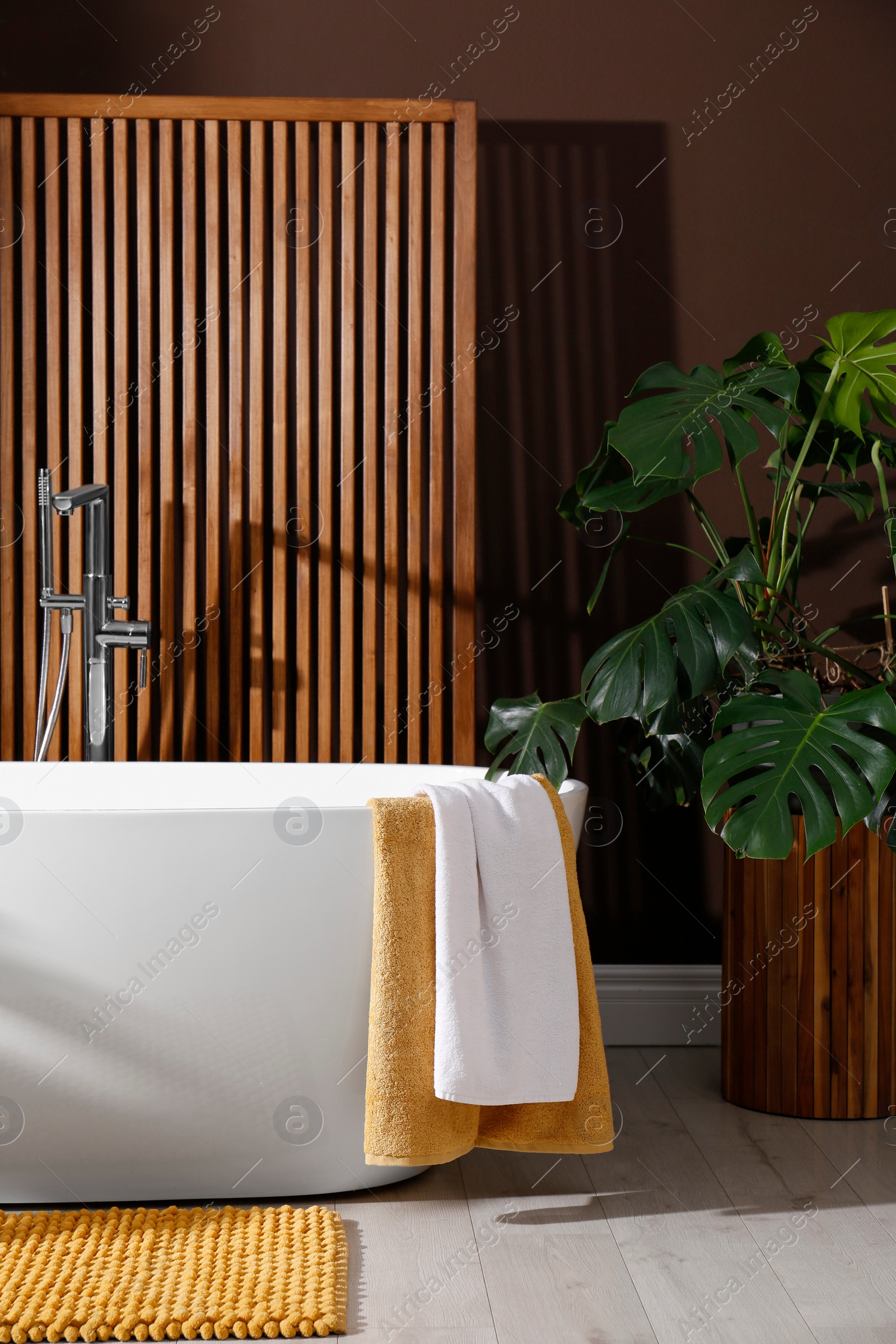 Photo of Cozy bathroom interior with stylish ceramic tub