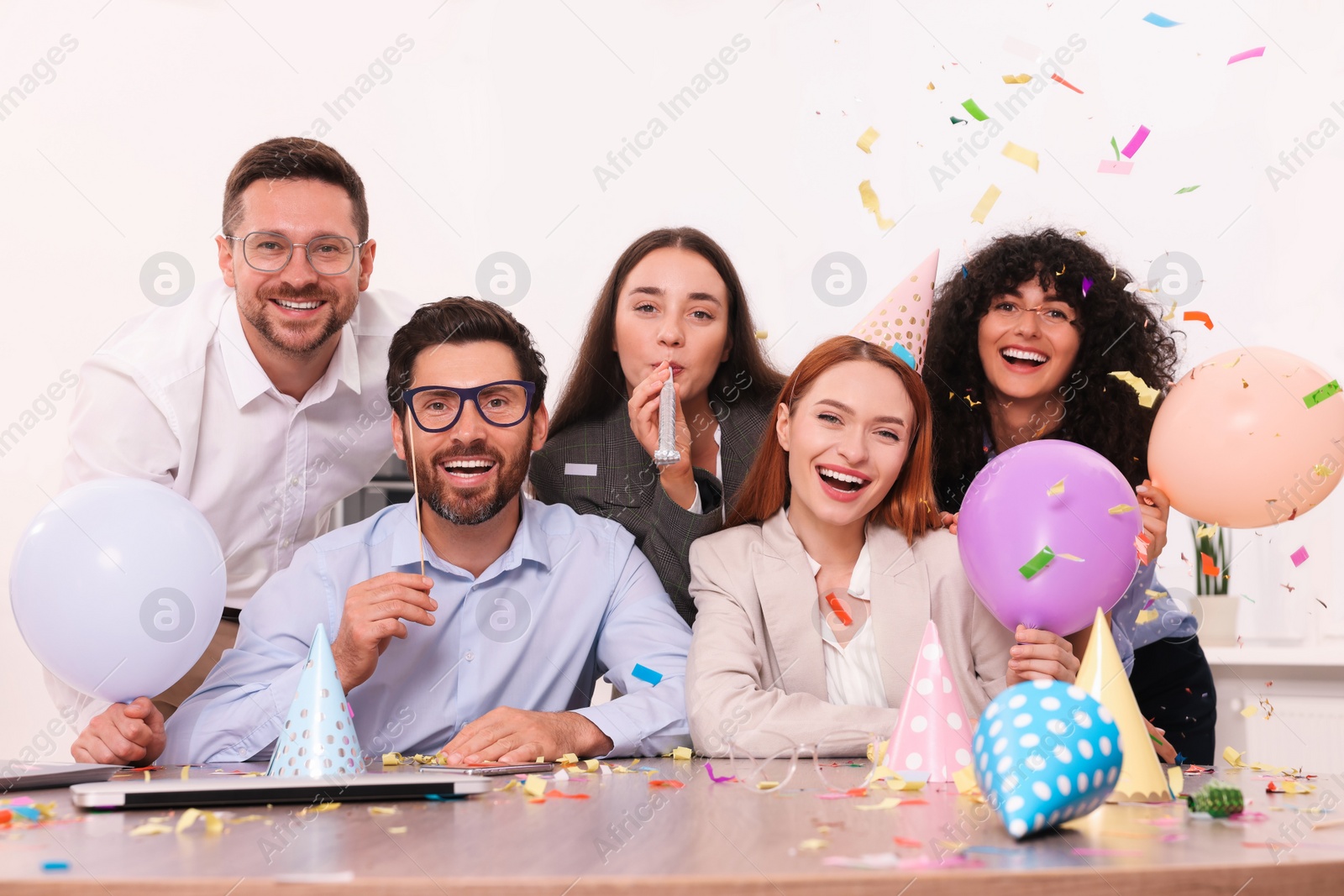 Photo of Coworkers having fun during office party indoors