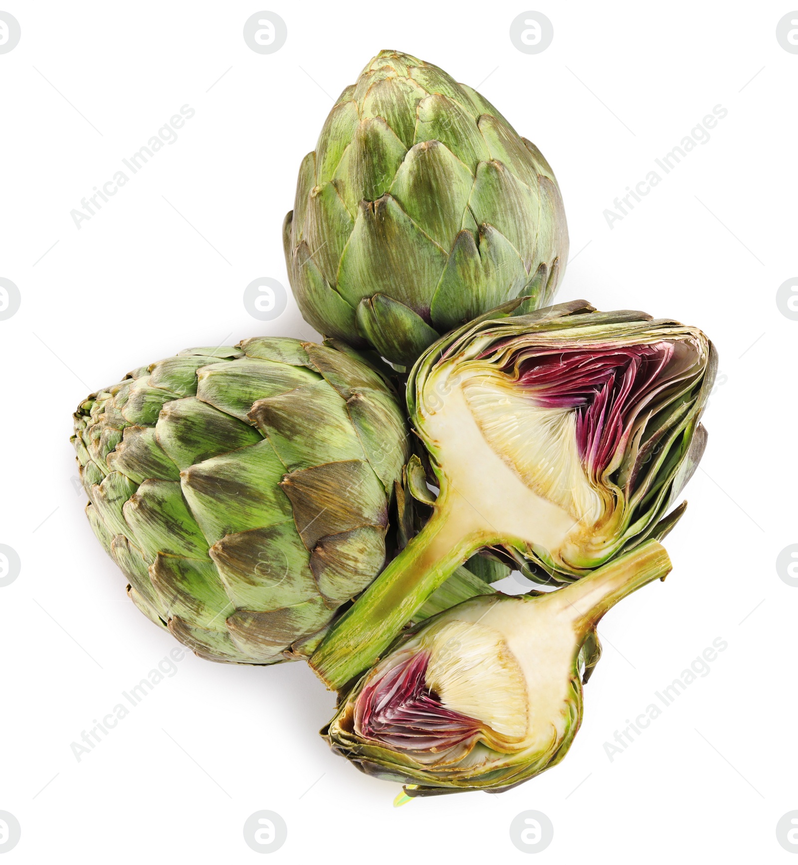 Photo of Cut and whole fresh artichokes on white background, top view