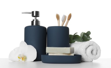 Photo of Bath accessories. Different personal care products, flower and eucalyptus branch on table against white background
