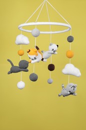 Cute baby crib mobile on yellow background