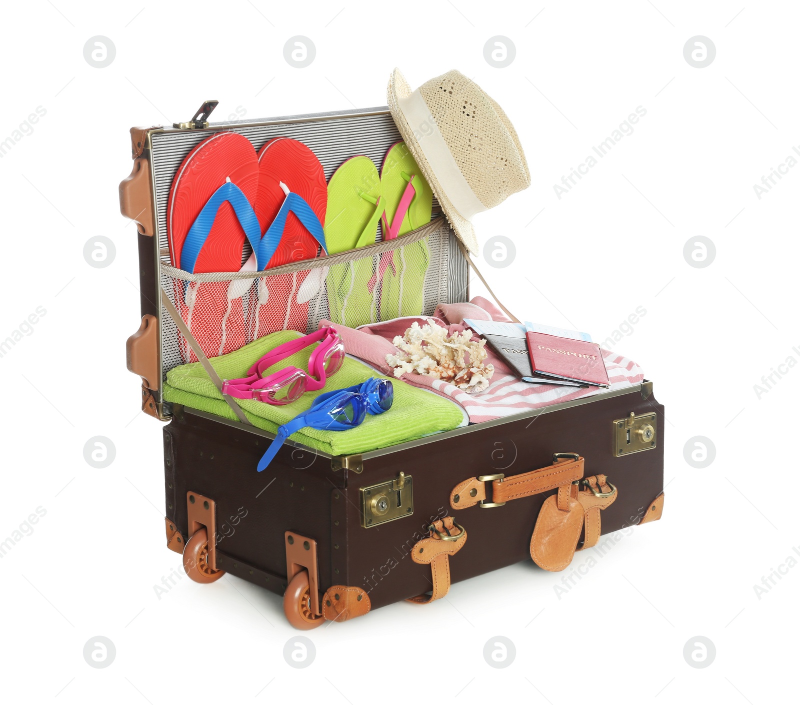 Photo of Open vintage suitcase with different beach objects packed for summer vacation isolated on white