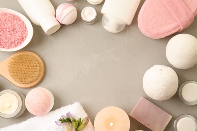 Flat lay composition with bath bombs, toiletries and space for text on grey background