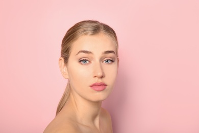 Portrait of young woman with beautiful natural eyelashes on color background. Space for text