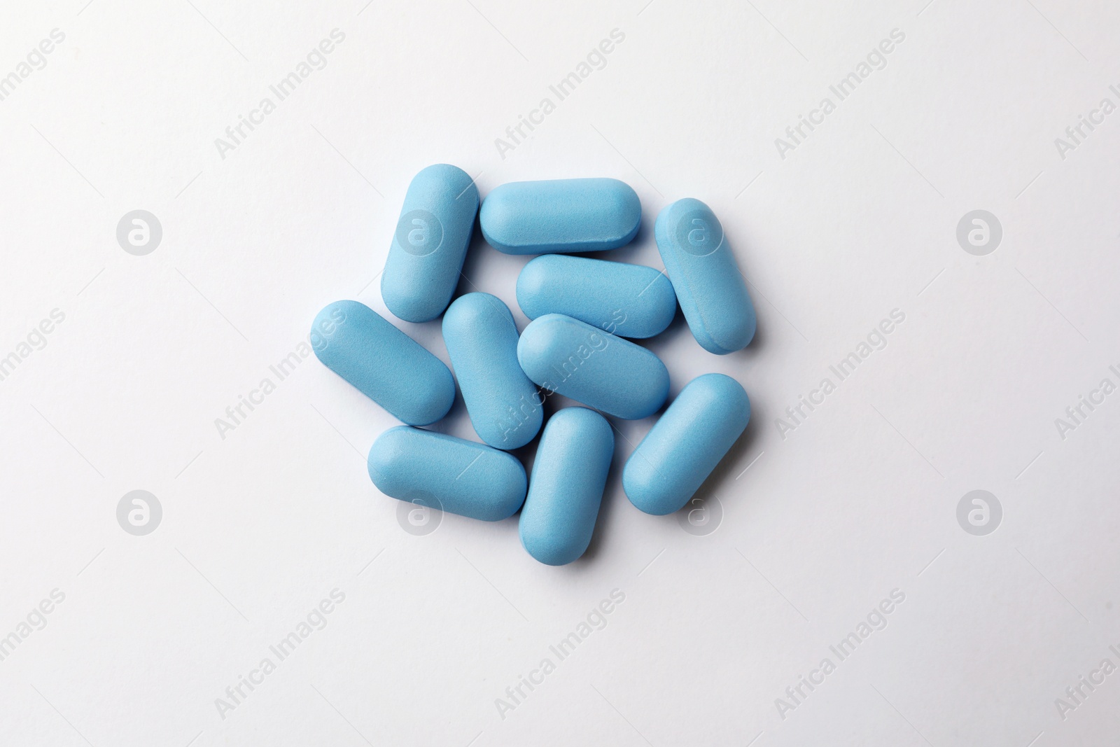 Photo of Pills on white background, top view. Potency problem