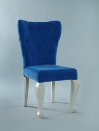 Photo of Stylish blue chair on light grey background. Element of interior design
