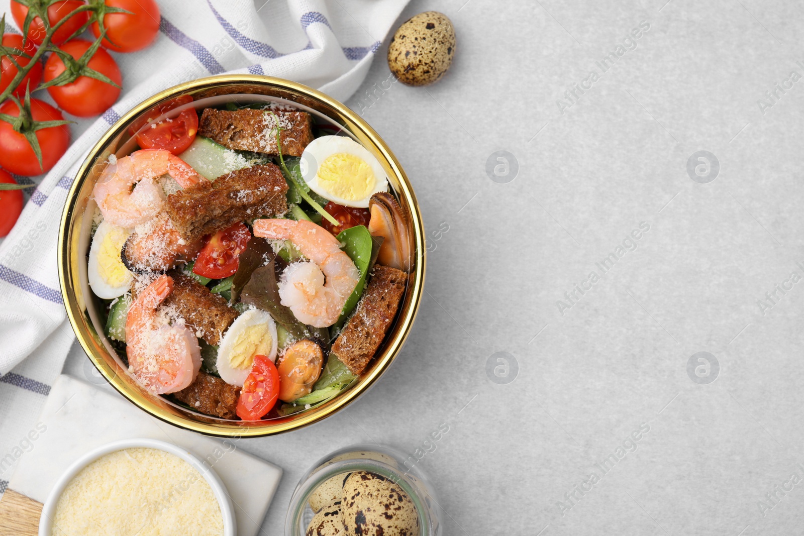 Photo of Delicious salad with croutons, tomatoes and shrimp served on white table, flat lay. Space for text