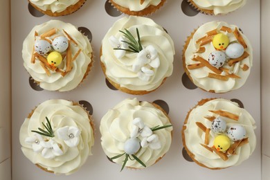 Photo of Tasty Easter cupcakes in box, top view