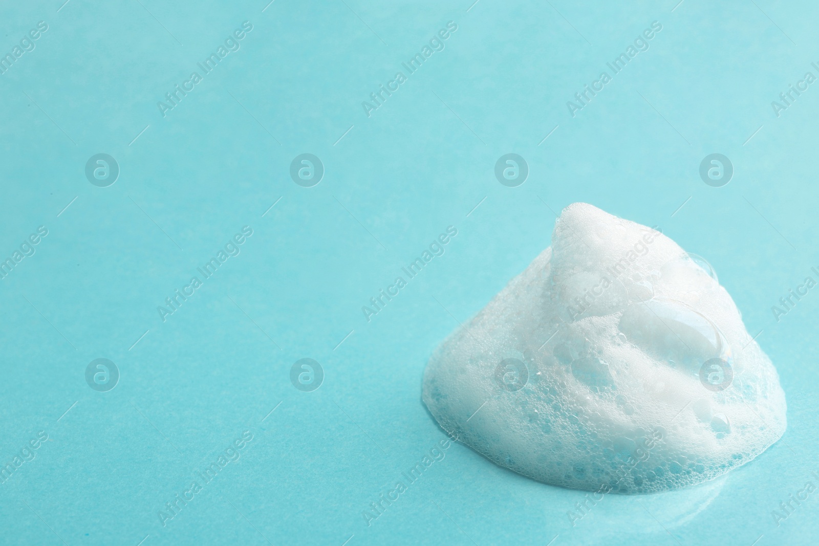 Photo of Drop of soap foam on color background. Space for text