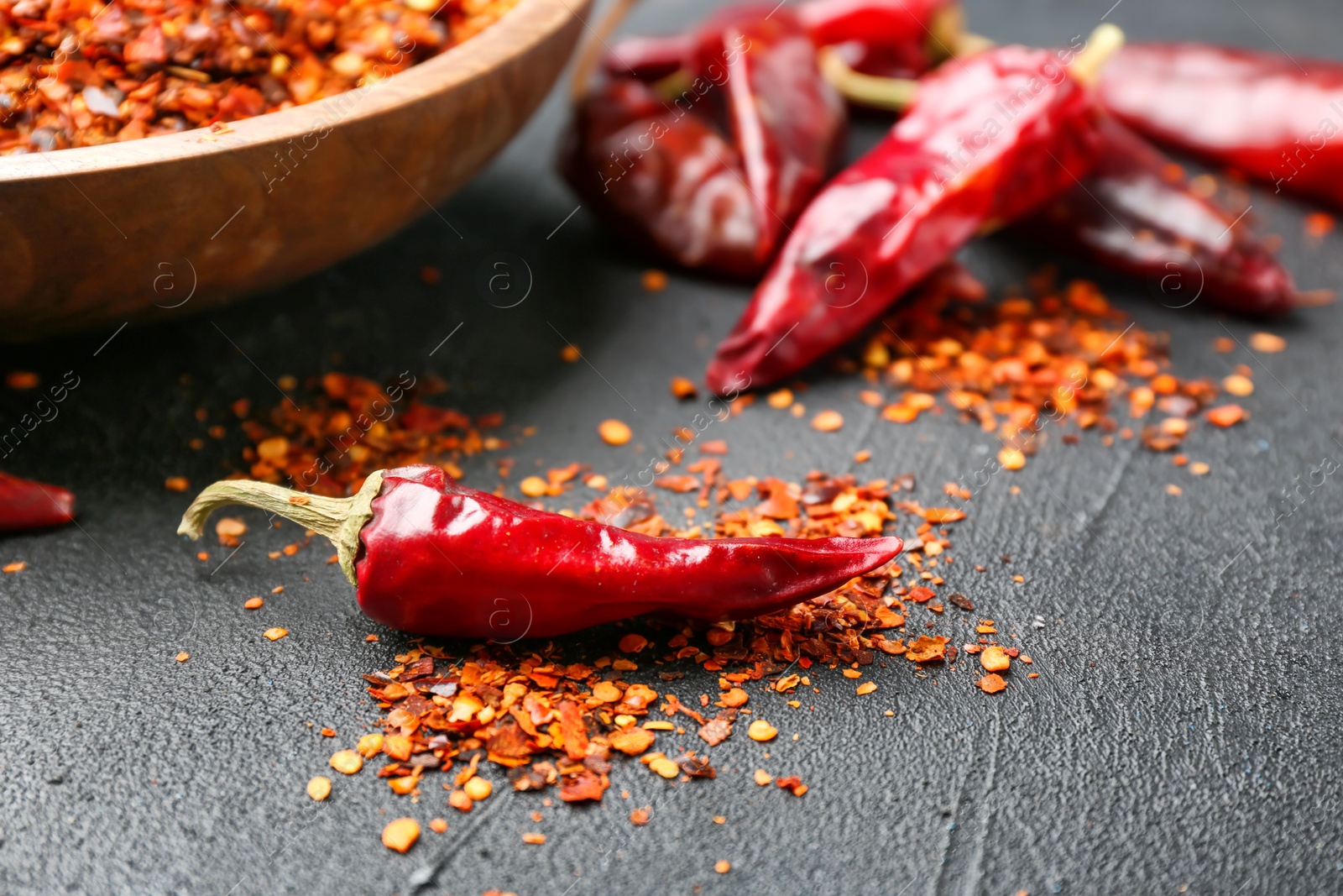 Photo of Dry chili peppers and flakes on table