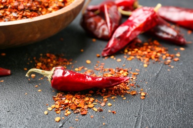 Photo of Dry chili peppers and flakes on table
