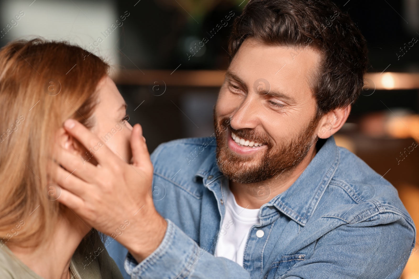 Photo of Romantic date. Happy couple spending time together indoors