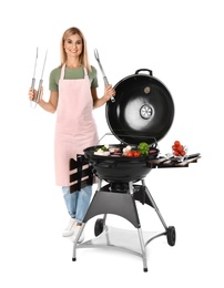Woman in apron cooking on barbecue grill, white background