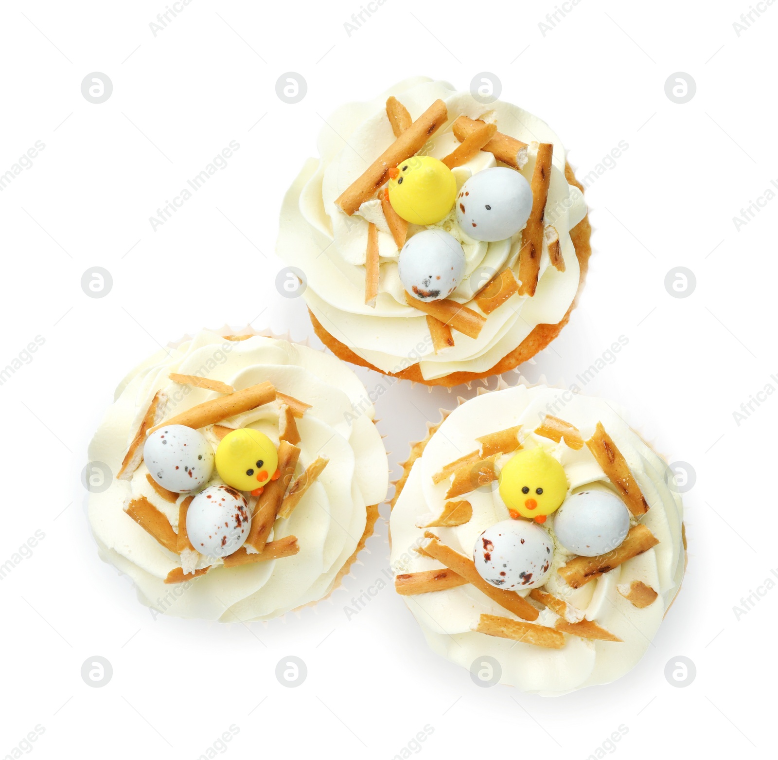 Photo of Tasty Easter cupcakes with vanilla cream isolated on white, top view