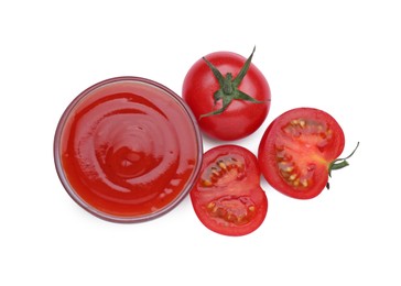 Photo of Bowl with tasty ketchup and fresh tomatoes isolated on white, top view
