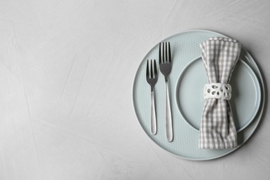 Beautiful table setting on grey background, top view. Space for text