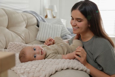 Young woman with her little baby at home