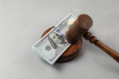 Photo of Judge's gavel and money on grey table