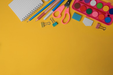 Photo of Flat lay composition with notebook and other school stationery on orange background, space for text. Back to school