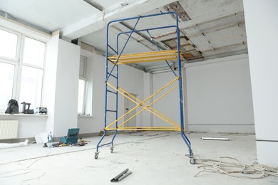 Photo of Scaffolds in messy room prepared for renovation