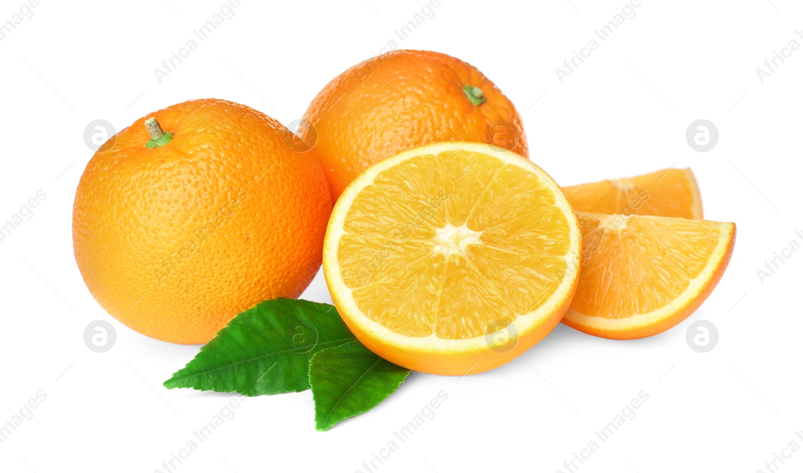 Photo of Cut and whole fresh ripe oranges with green leaves on white background