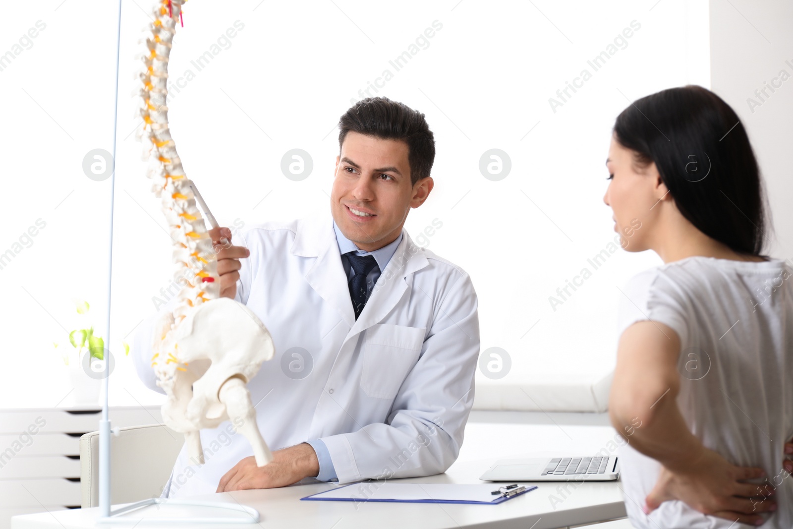 Photo of Young woman visiting orthopedist in medical office