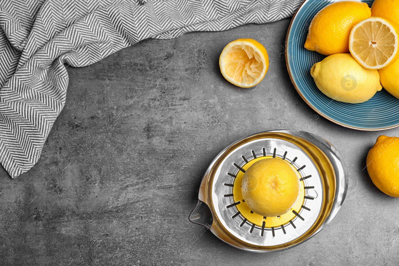 Photo of Flat lay composition with squeezer, fresh lemons and space for text on table
