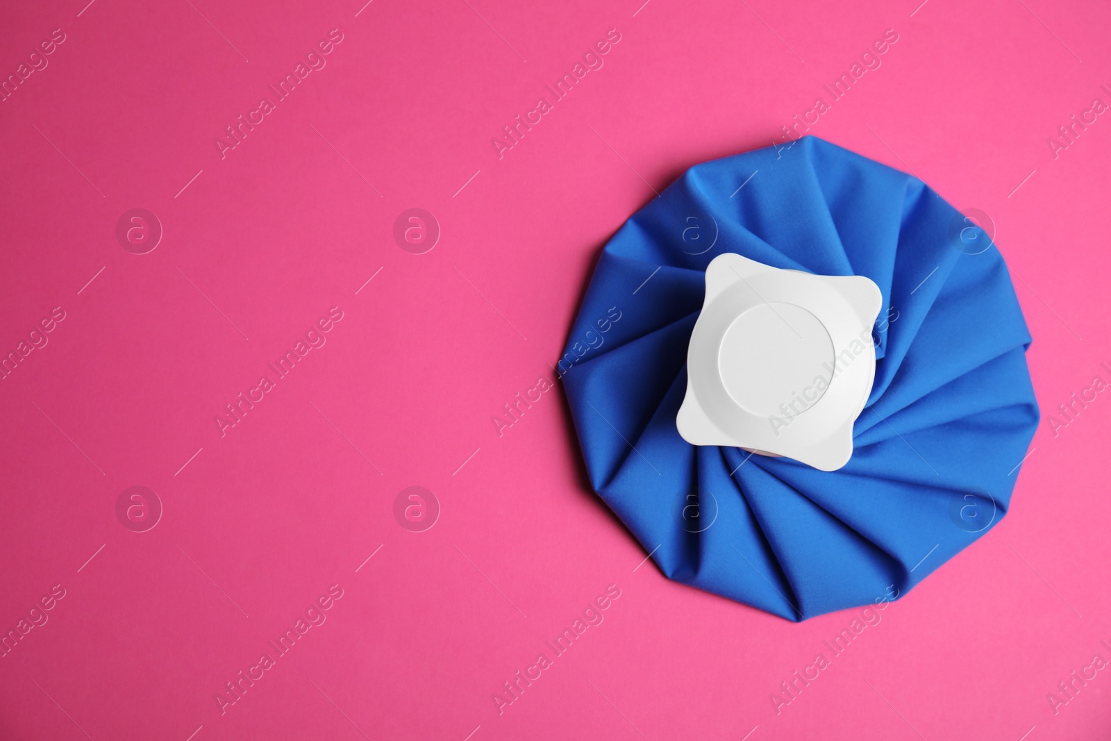Photo of Ice pack on pink background, top view. Space for text