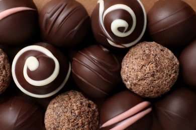 Photo of Many different delicious chocolate truffles, top view