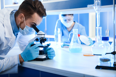 Scientist working with microscope indoors. Laboratory analysis